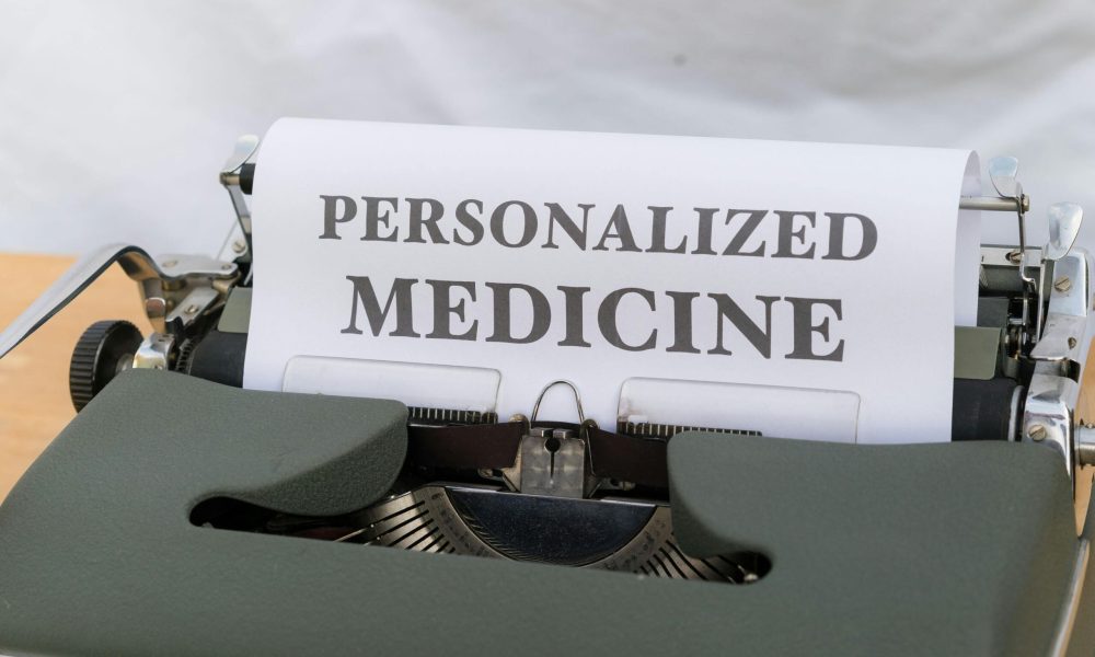 An old-fashioned typewriter displaying a paper with 'Personalized Medicine' text, emphasizing custom healthcare.